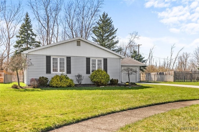view of front facade featuring an attached garage, fence, a front lawn, and concrete driveway