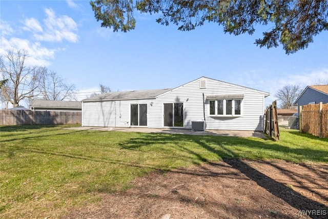 rear view of property featuring central air condition unit, a yard, a patio area, and fence