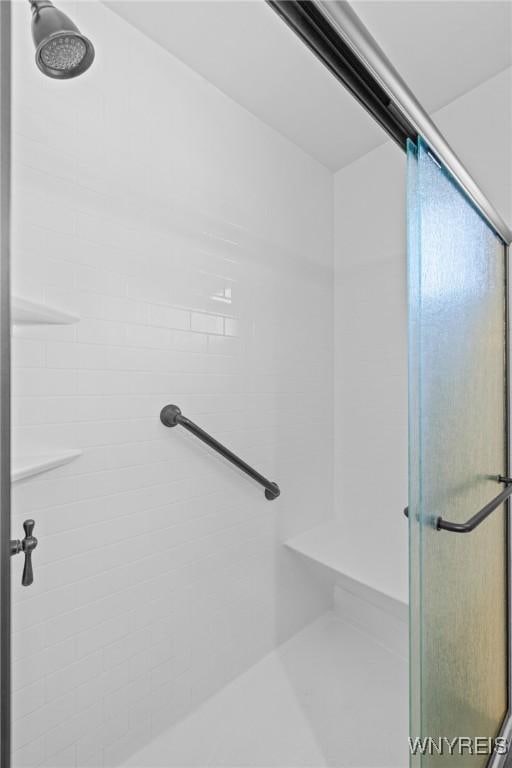 bathroom with tiled shower