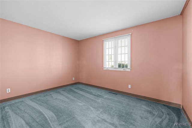 carpeted empty room with visible vents and baseboards