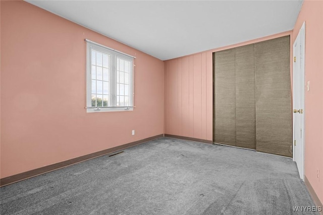 interior space featuring visible vents, baseboards, and carpet