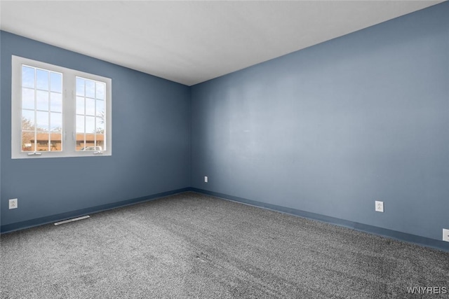 carpeted empty room with baseboards