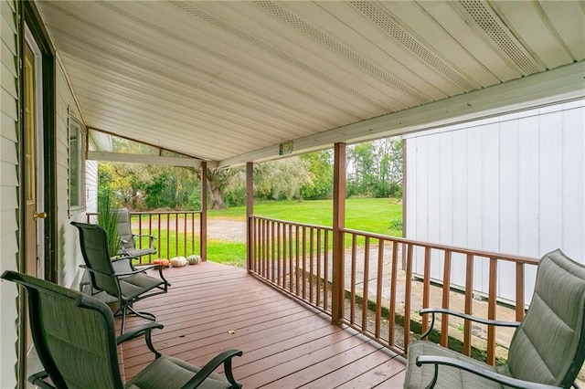wooden deck with a yard