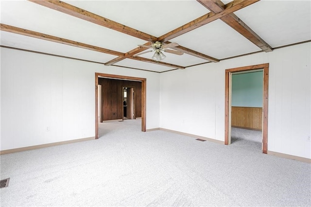 empty room with beamed ceiling, carpet flooring, ceiling fan, coffered ceiling, and baseboards