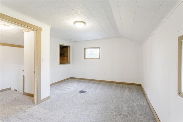additional living space featuring visible vents, carpet flooring, and baseboards