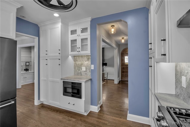 mudroom featuring a baseboard radiator, arched walkways, dark wood-type flooring, and baseboards