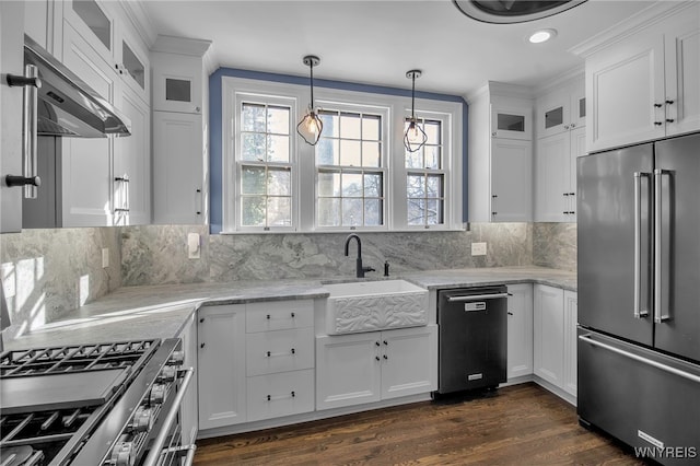 kitchen with decorative backsplash, white cabinetry, a sink, and appliances with stainless steel finishes