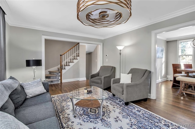 living area with baseboards, dark wood-style flooring, ornamental molding, a baseboard radiator, and stairway