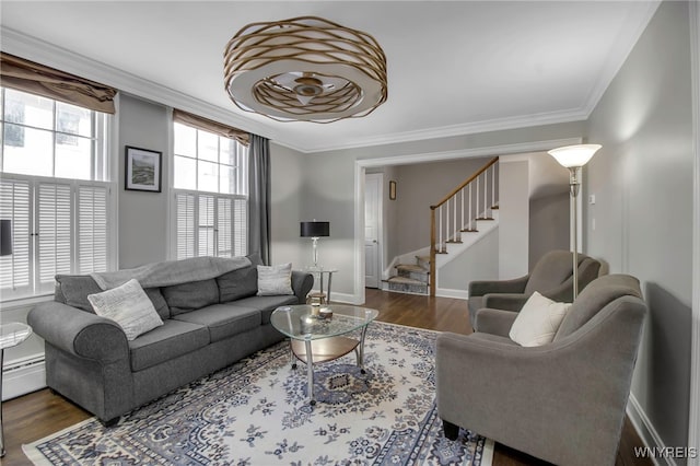 living room featuring crown molding, wood finished floors, and stairway