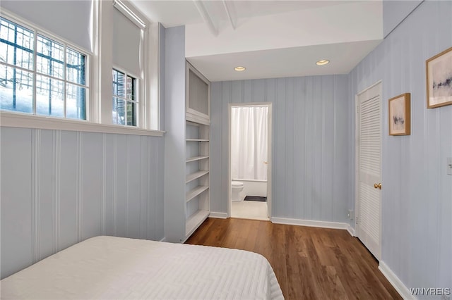 bedroom with wood finished floors, ensuite bathroom, baseboards, and recessed lighting