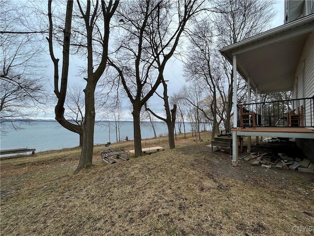 view of yard with a deck with water view