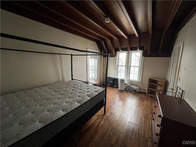 bedroom with wood-type flooring and vaulted ceiling with beams