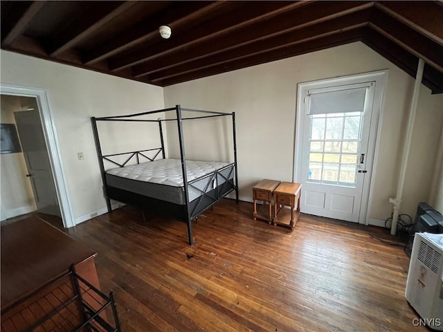 bedroom with lofted ceiling and wood finished floors