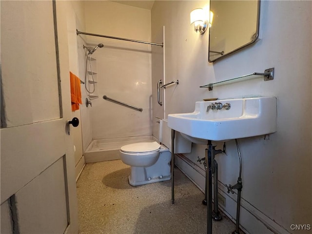 full bathroom featuring a sink, toilet, and a shower stall