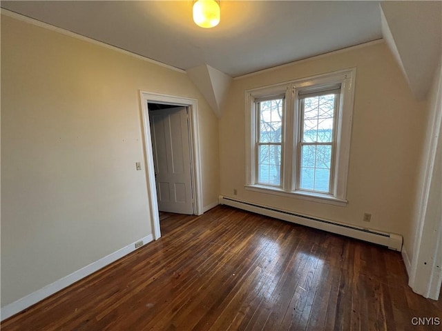 interior space with baseboard heating, baseboards, ornamental molding, and dark wood-style floors