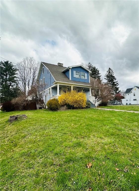 930 W 1st St, Elmira, NY 14905 - view of home's exterior with a yard and a chimney
