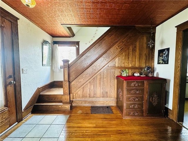 930 W 1st St, Elmira, NY 14905 - additional living space with an ornate ceiling, hardwood / wood-style flooring, wooden walls, and stairs