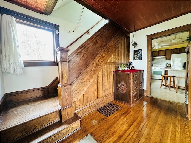 930 W 1st St, Elmira, NY 14905 - stairs featuring hardwood / wood-style floors and wooden walls