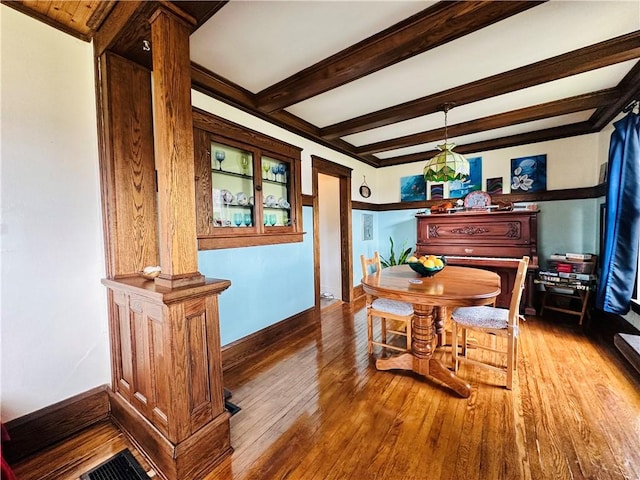 930 W 1st St, Elmira, NY 14905 - dining room featuring hardwood / wood-style floors, beam ceiling, and baseboards