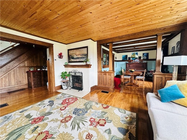 930 W 1st St, Elmira, NY 14905 - living area with a fireplace with flush hearth, wood-type flooring, wood ceiling, stairs, and baseboards