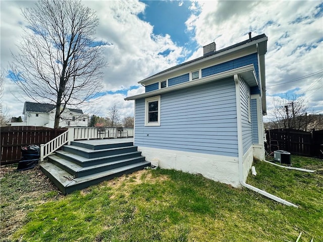 930 W 1st St, Elmira, NY 14905 - rear view of property with a wooden deck, a chimney, and central air condition unit