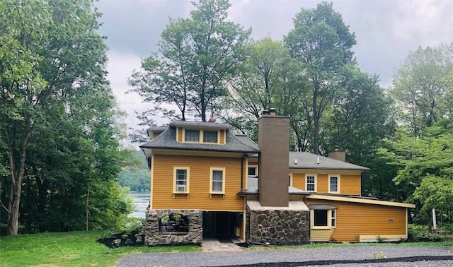 16441 W Lake Rd, Pulteney, NY 14418 - back of house featuring a chimney, stone siding, and a yard