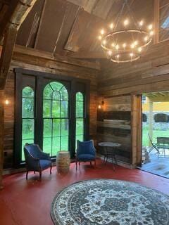 16441 W Lake Rd, Pulteney, NY 14418 - living area featuring a chandelier, wood walls, and wood finished floors