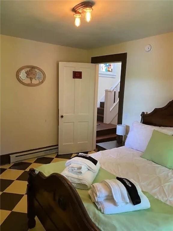 16441 W Lake Rd, Pulteney, NY 14418 - bedroom with baseboard heating, tile patterned floors, and baseboards