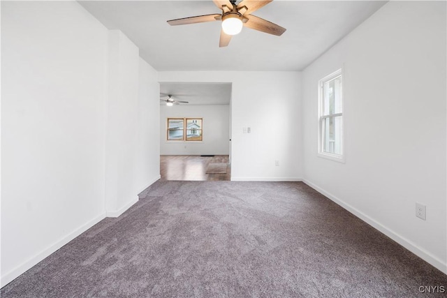 empty room featuring carpet floors, ceiling fan, baseboards, and a wealth of natural light
