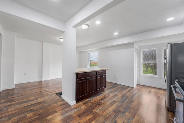 kitchen with freestanding refrigerator, dark brown cabinets, dark wood-style floors, light countertops, and electric range oven