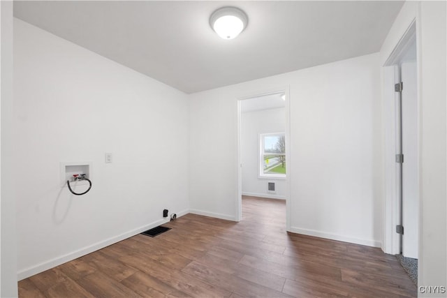 laundry area with laundry area, visible vents, wood finished floors, baseboards, and hookup for a washing machine