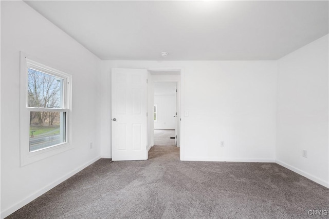 unfurnished bedroom with carpet floors and baseboards