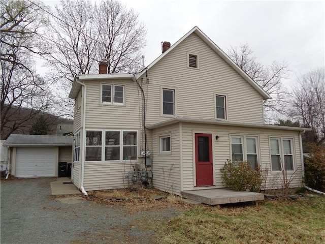 252 W 2nd St, Corning-City, NY 14830 - back of house featuring a chimney, driveway, a detached garage, and an outdoor structure