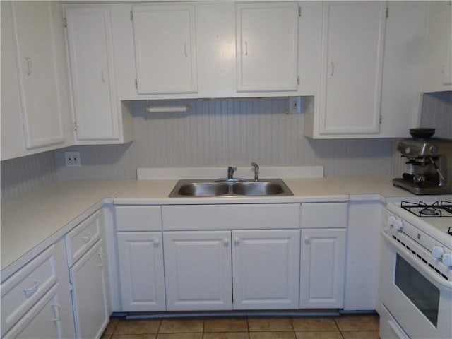 252 W 2nd St, Corning-City, NY 14830 - kitchen with a sink, light countertops, white cabinets, and gas range gas stove