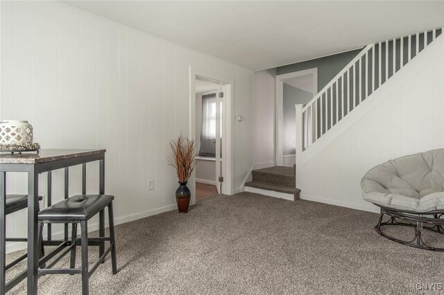 interior space featuring baseboards, carpet, and stairs