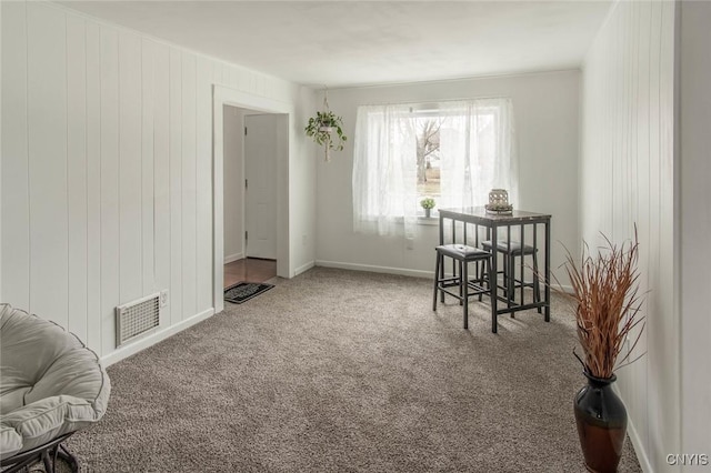 interior space featuring visible vents, baseboards, and carpet flooring