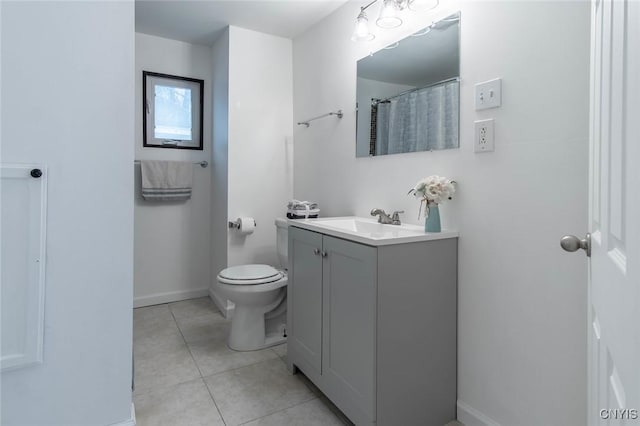full bath featuring tile patterned floors, toilet, vanity, and baseboards