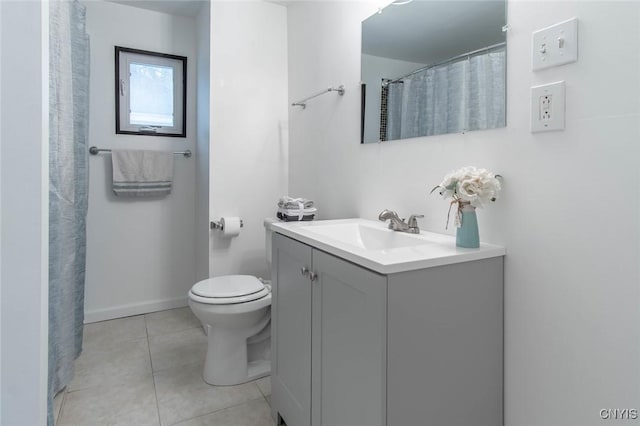 bathroom featuring tile patterned flooring, curtained shower, vanity, and toilet