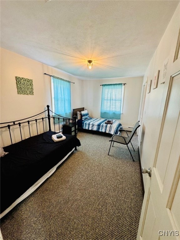 carpeted bedroom featuring a textured ceiling