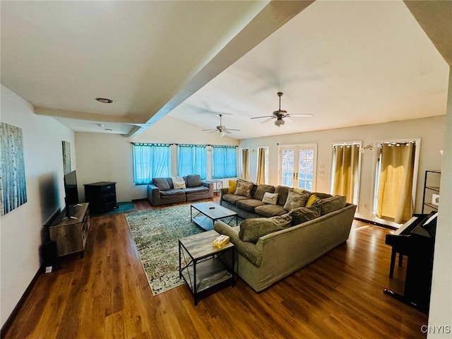 living room with a wealth of natural light, a ceiling fan, and dark wood finished floors