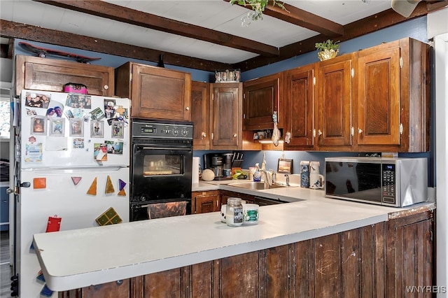 192 Pine St, Lockport City, NY 14094 - kitchen featuring stainless steel microwave, light countertops, freestanding refrigerator, beam ceiling, and a sink