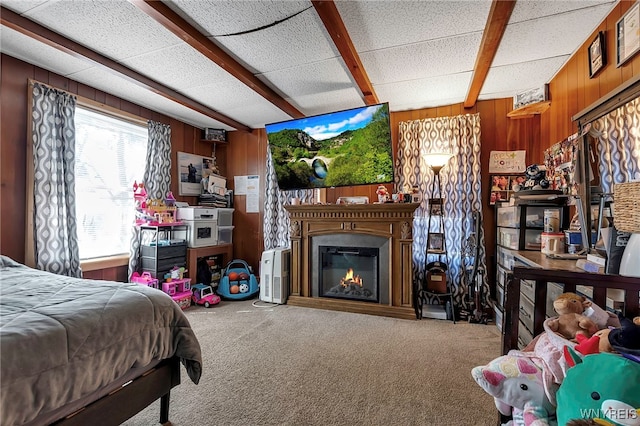 192 Pine St, Lockport City, NY 14094 - bedroom with carpet flooring, a glass covered fireplace, wooden walls, and beamed ceiling