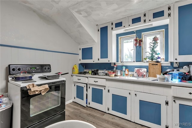 192 Pine St, Lockport City, NY 14094 - kitchen with light wood-type flooring, light countertops, electric range, and white cabinetry