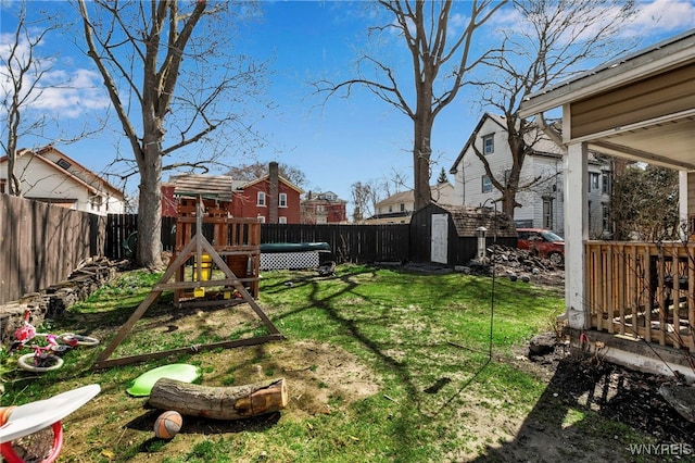 192 Pine St, Lockport City, NY 14094 - view of yard featuring a fenced backyard, an outdoor structure, a playground, and a storage unit