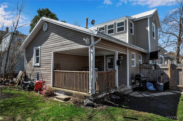 192 Pine St, Lockport City, NY 14094 - rear view of house featuring a porch, fence, and a lawn