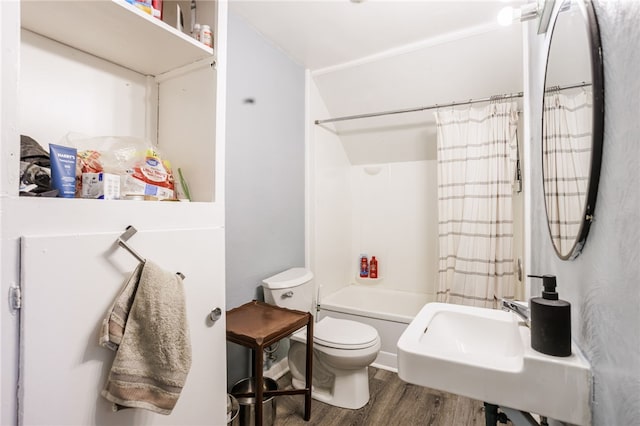 bathroom with toilet, shower / tub combo, wood finished floors, and a sink