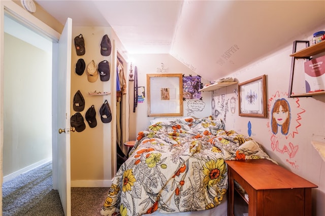 bedroom featuring baseboards, carpet flooring, and vaulted ceiling