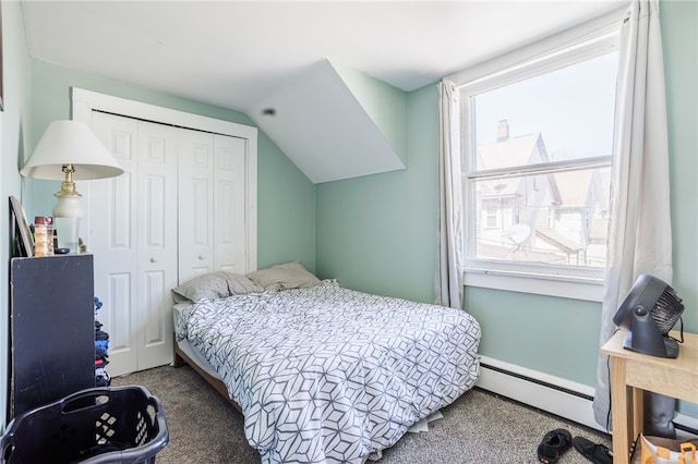 bedroom featuring a closet, carpet flooring, a baseboard radiator, and lofted ceiling