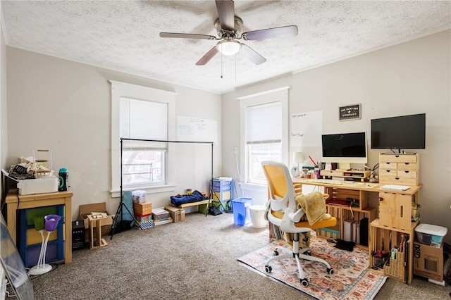 carpeted home office featuring a textured ceiling and a ceiling fan