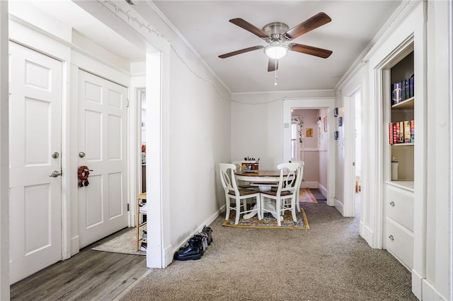 dining space featuring crown molding, ceiling fan, carpet flooring, and baseboards